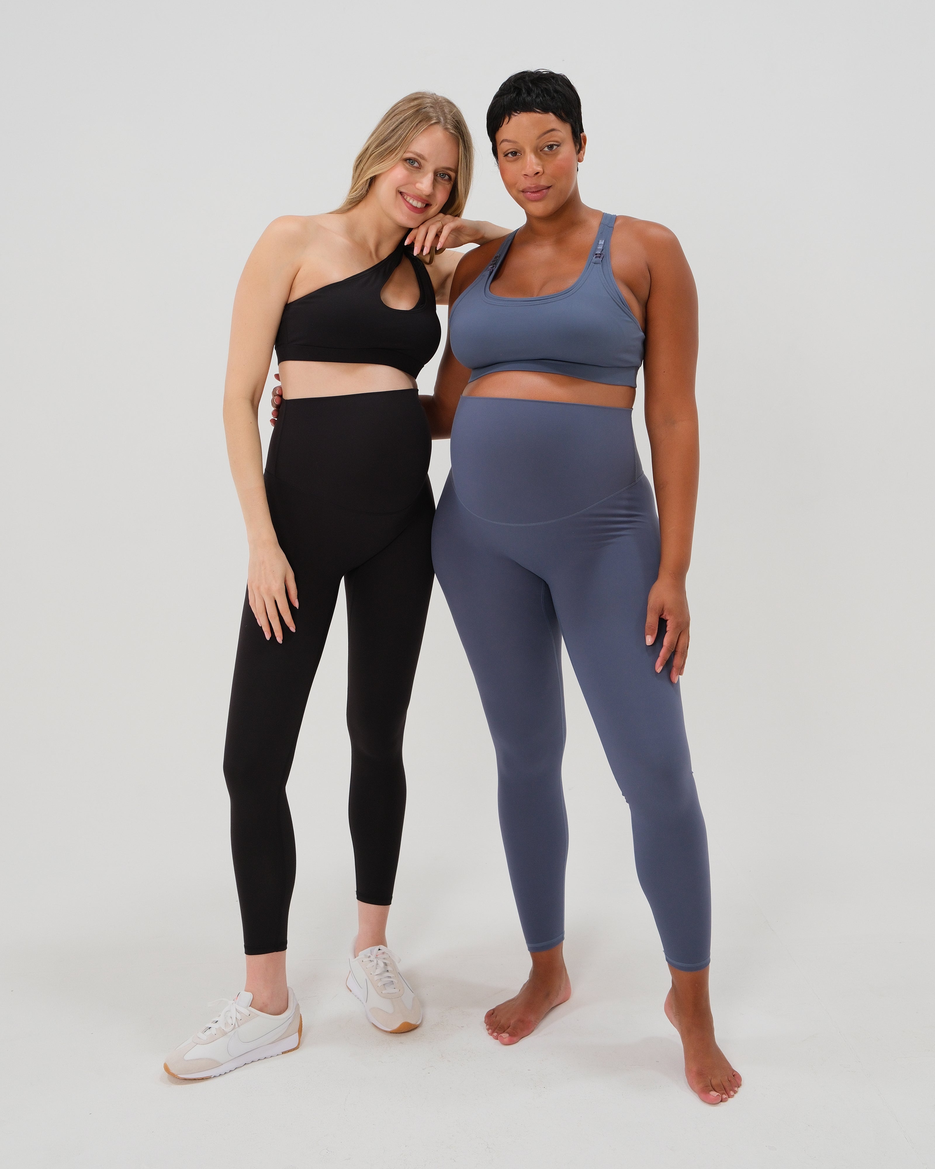 Plus size and slim pregnant women wearing our best reviewed AXK premium black and blue maternity leggings for 2026 with a matching trendy one shoulder nursing sports bras. Premium maternity athletic and activewear by AXK, available in plus sizes. Petite and tall friendly.